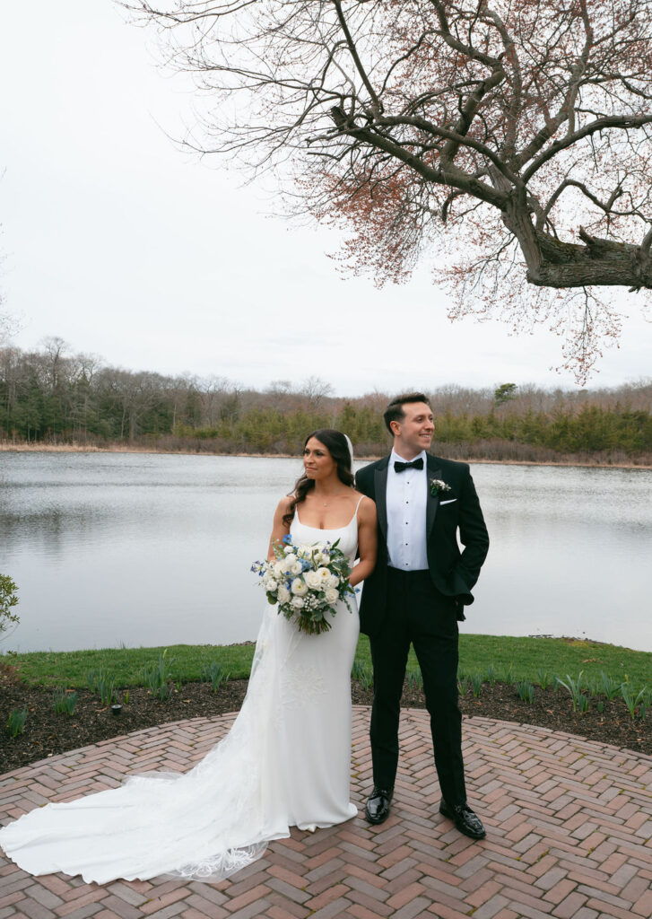Bride & Groom standing side by side at The Mill Lakeside Manor in Spring Lake after their first look
